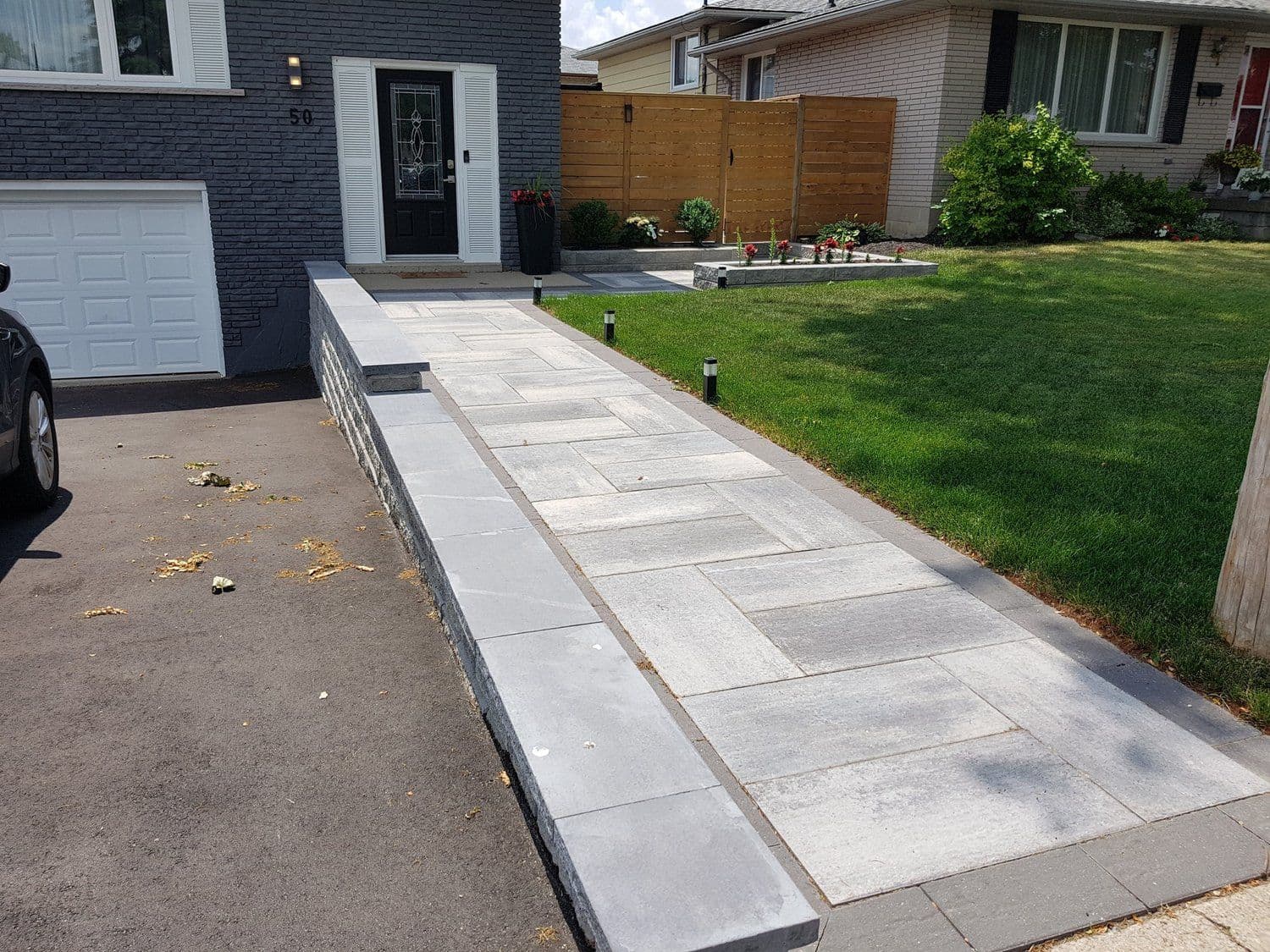 Paver walkway with stone steps and lawn, built by Dirty Boyz